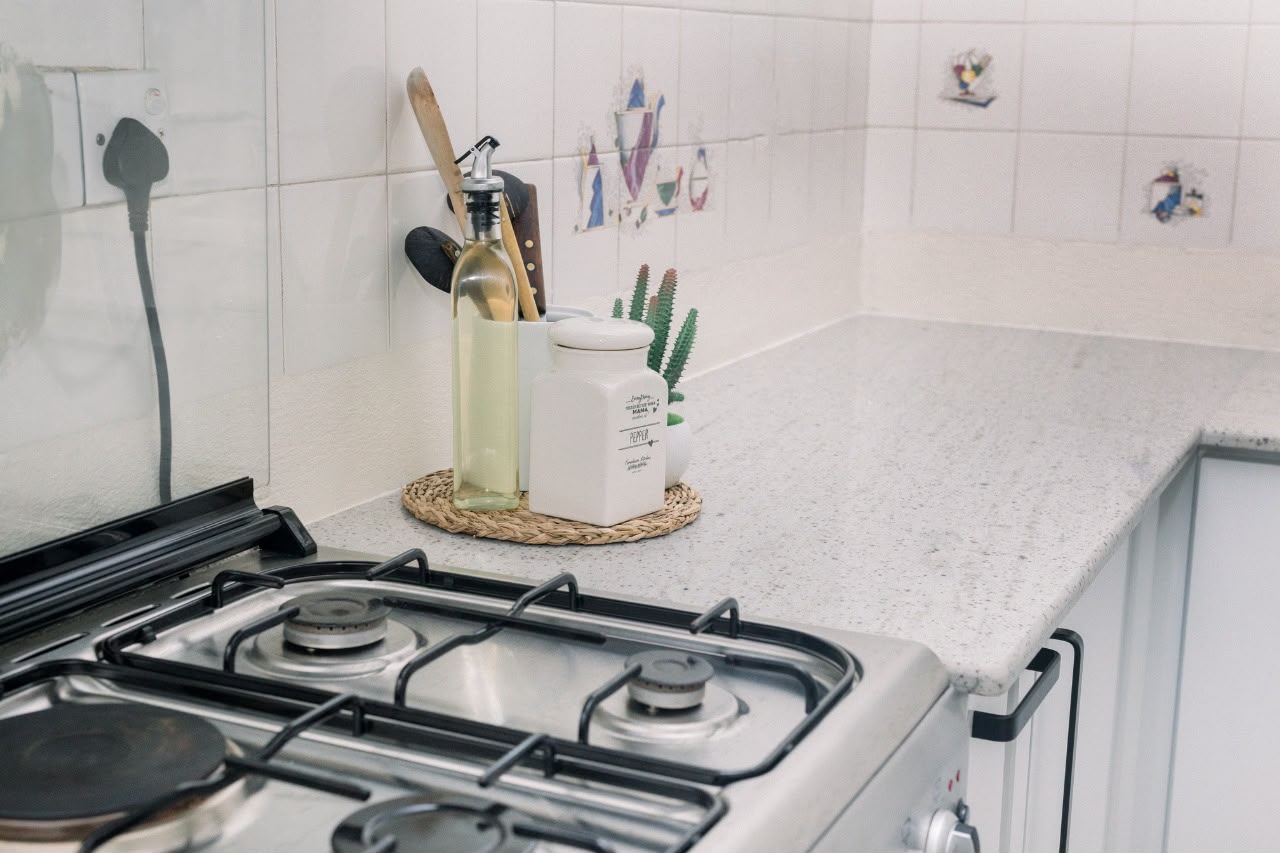 White speckled countertop with gas stove detail